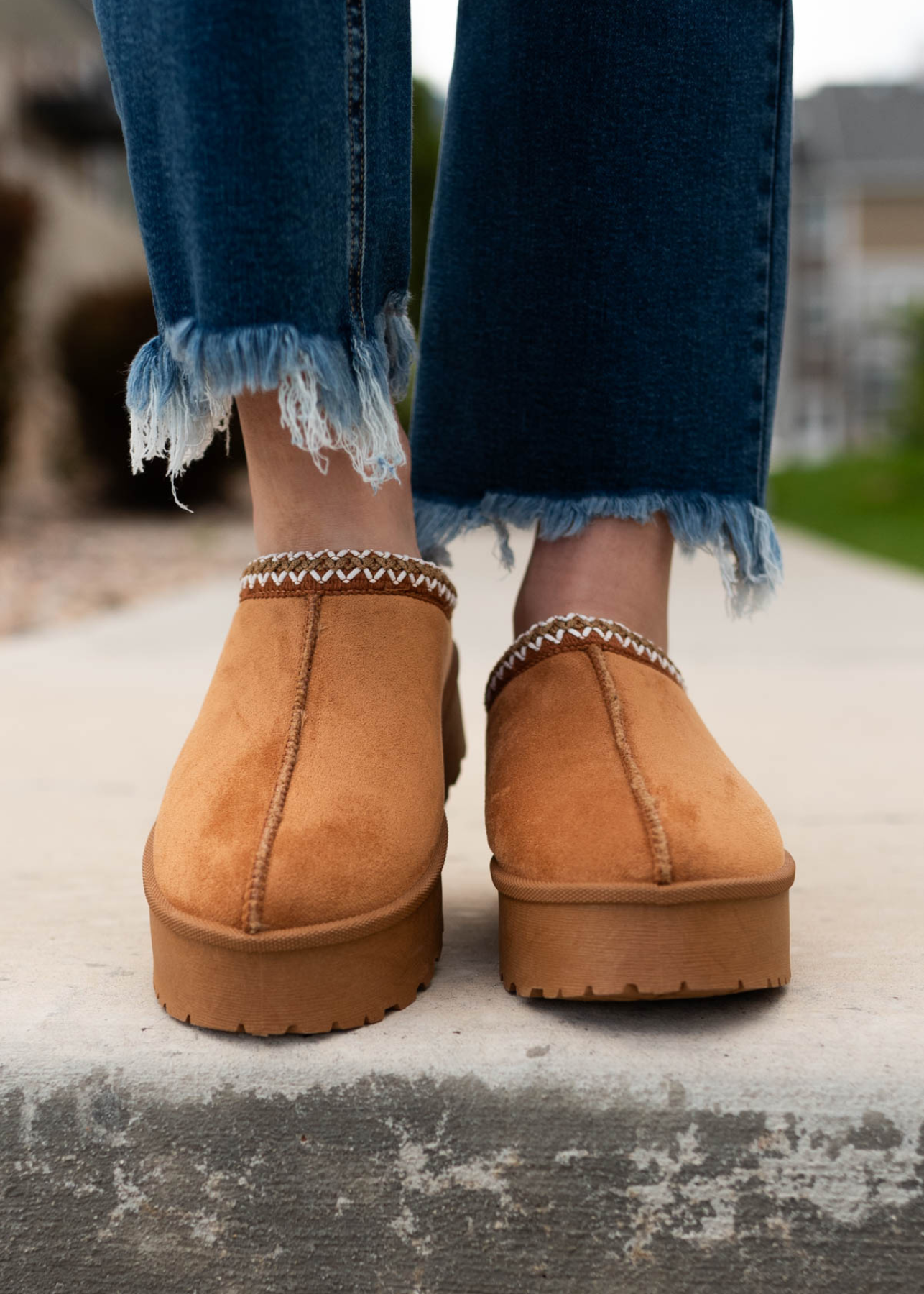 Front view of the tan suede clogs