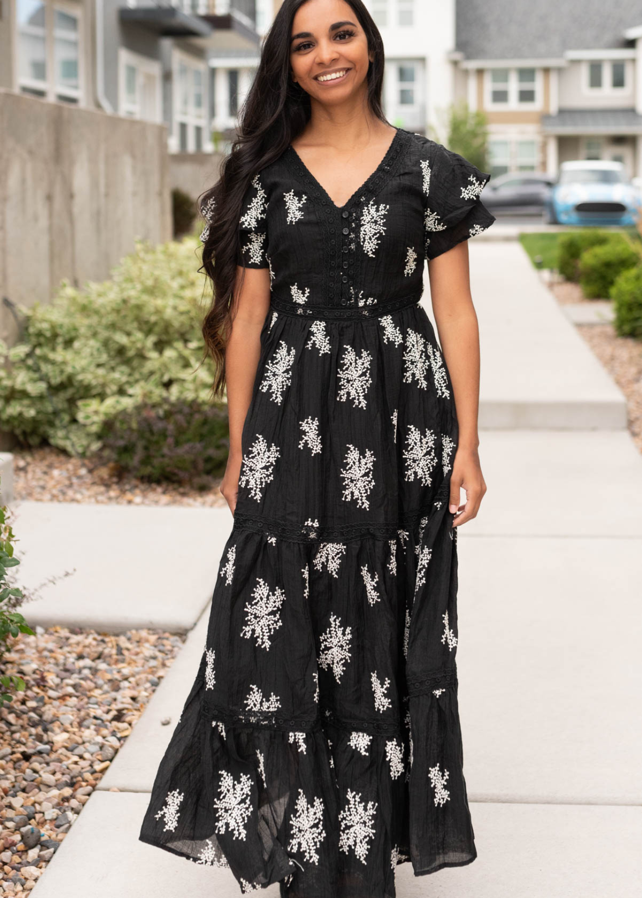 Short sleeve black embroidered tiered dress with buttons on the bodice