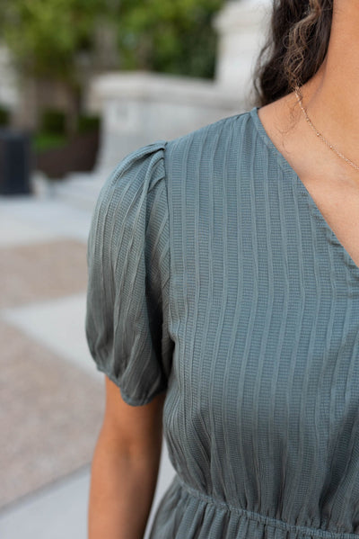 Close up of the fabric and sleeve on the olive tiered dress