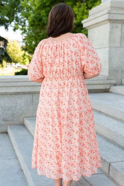 Back view of the plus size peach floral tiered dress