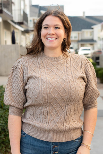 Multi knit pattern on the plus size taupe short sleeve sweater