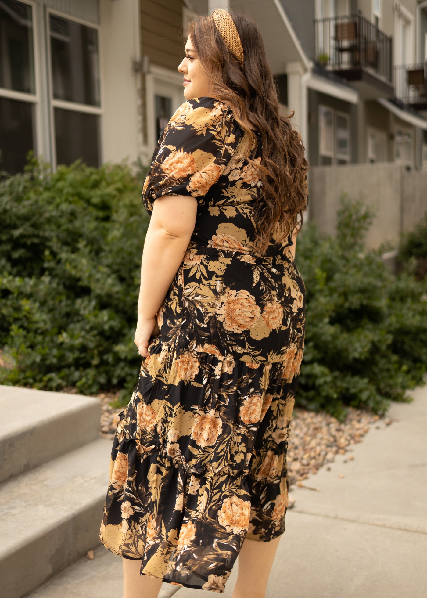 Side view of a plus size black floral dress