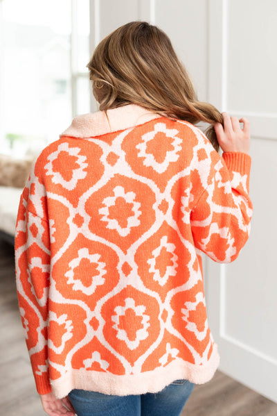 Back view of a long sleeve orange sherpa jacket