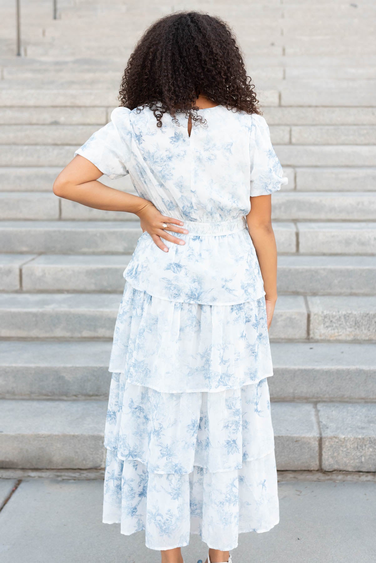 Back view of the light grey floral ruffle dress