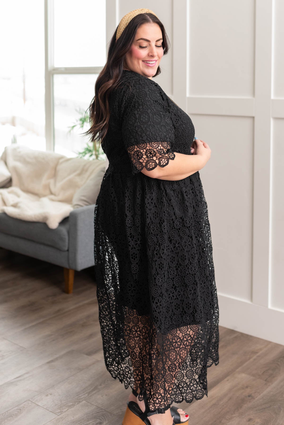 Side view of a plus size black lace dress