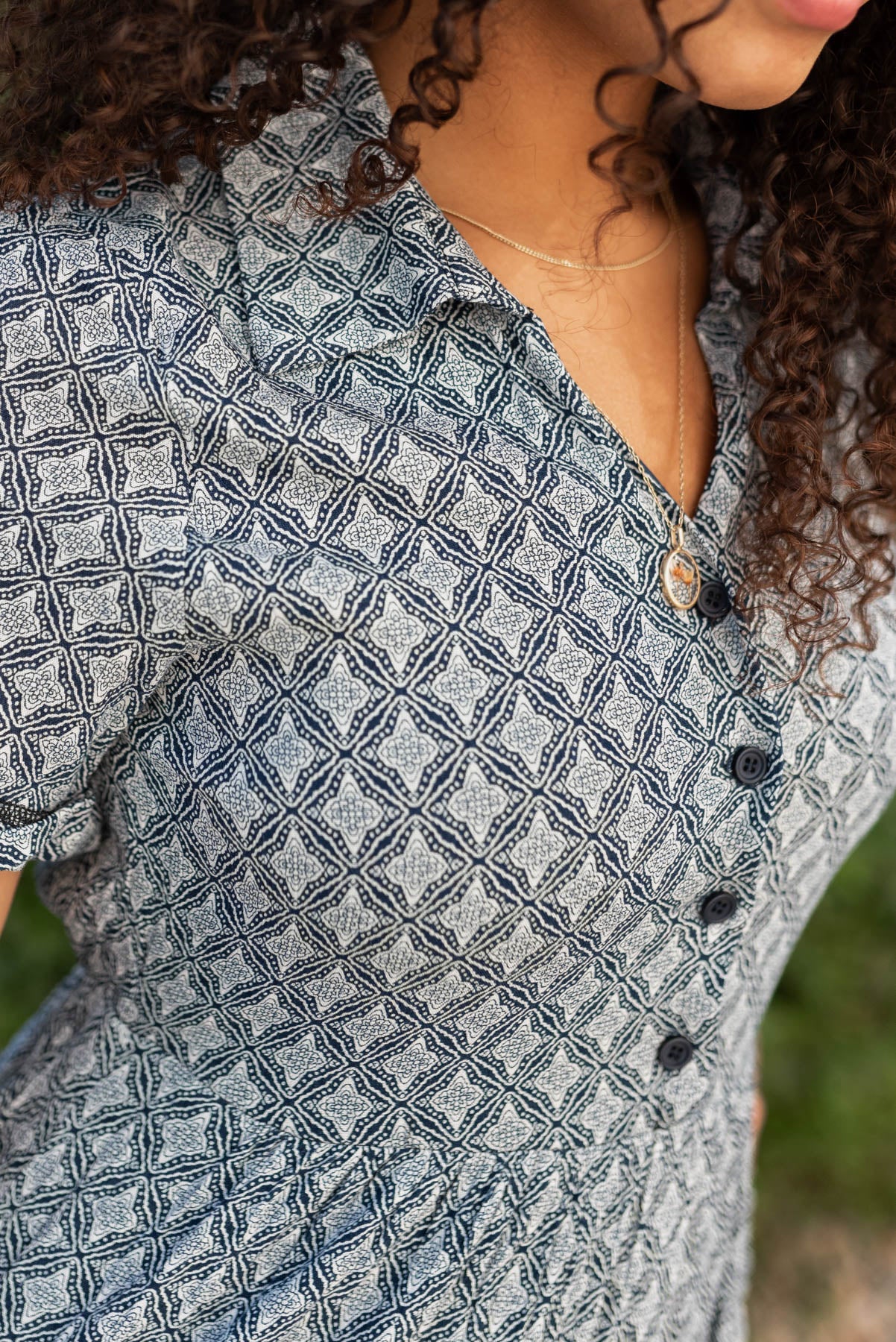 Close up of the bodice  and buttons on the navy pattern tiered dress