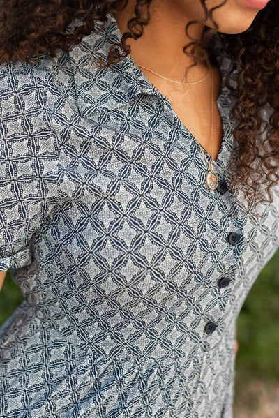 Close up of the bodice  and buttons on the navy pattern tiered dress