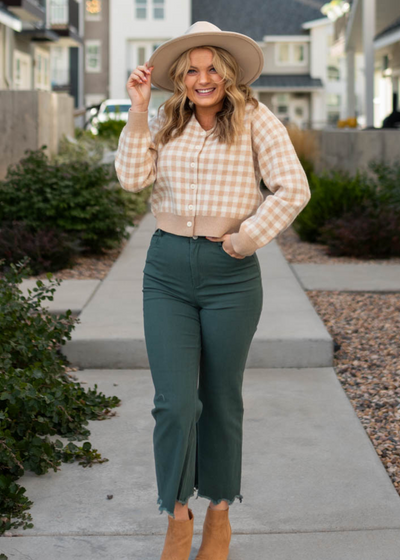 Front view of a taupe checkered button cardigan