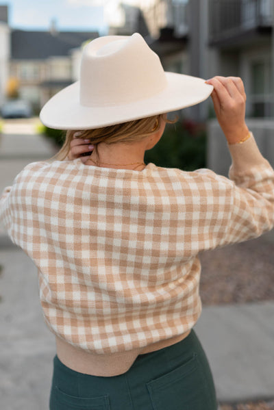 Back view of a taupe checkered button cardigan