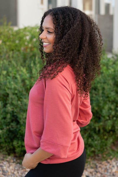 Close up side view of the terracotta pullover