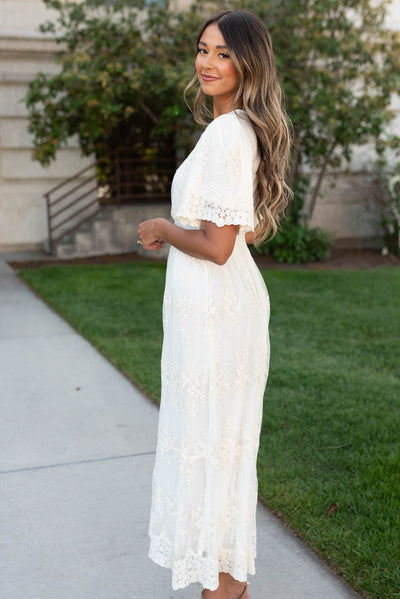 Side view of the cream lace embroidered dress