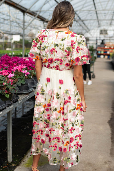 Back view of the magenta floral embroidered mesh dress