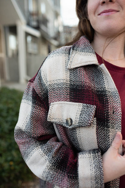 Close up of the pocket of the plus size burgundy pattern shacket