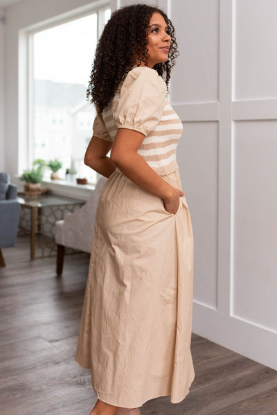 Side view of a sand strip knit dress