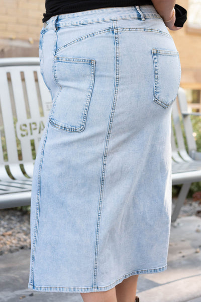 Side view of the light denim pencil skirt with front and back pockets in plus size