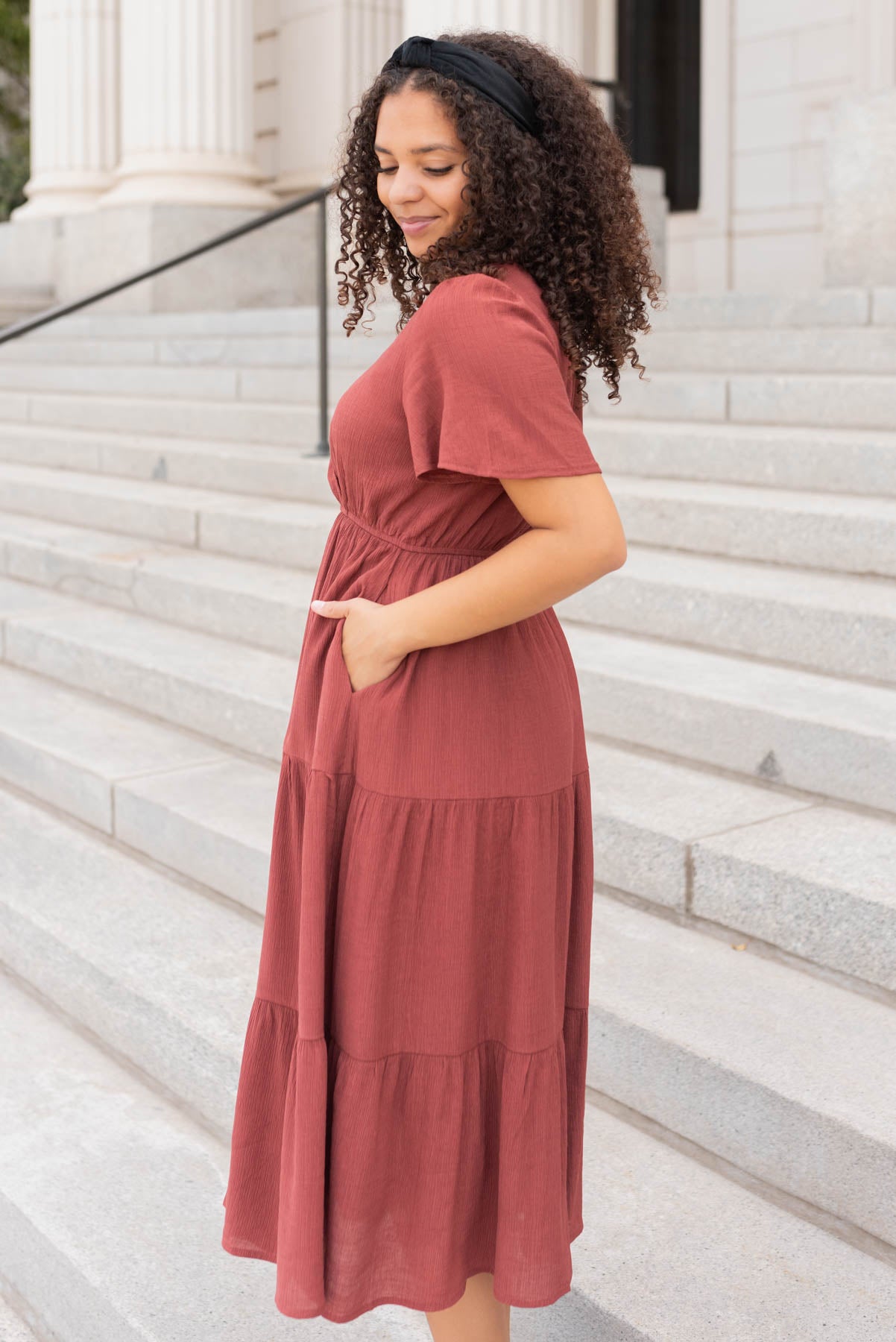 Side view of the terracotta tiered wrap dress