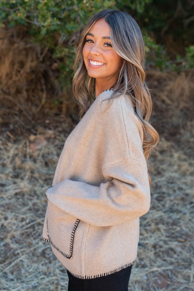 Side view of the taupe stitch pocket sweater