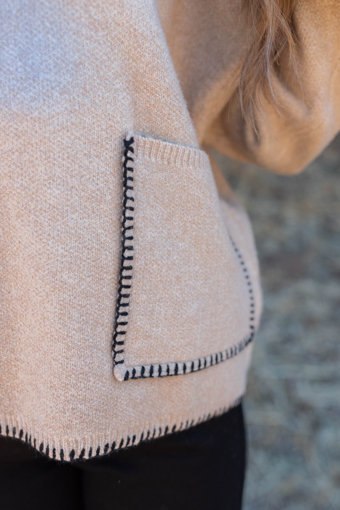 Close up of the pocket and stitching on the taupe stitch pocket sweater