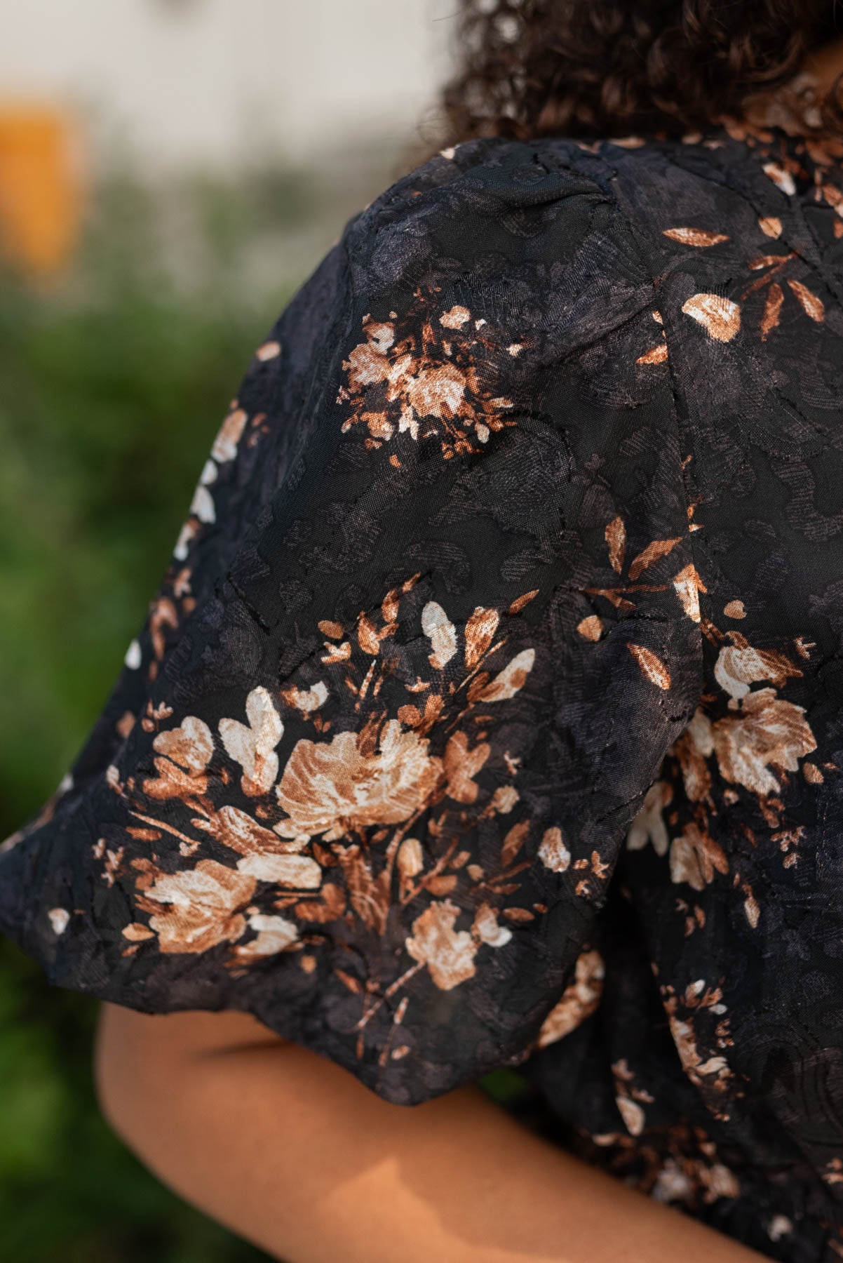 Close up of the sleeve and fabric on the black floral dress