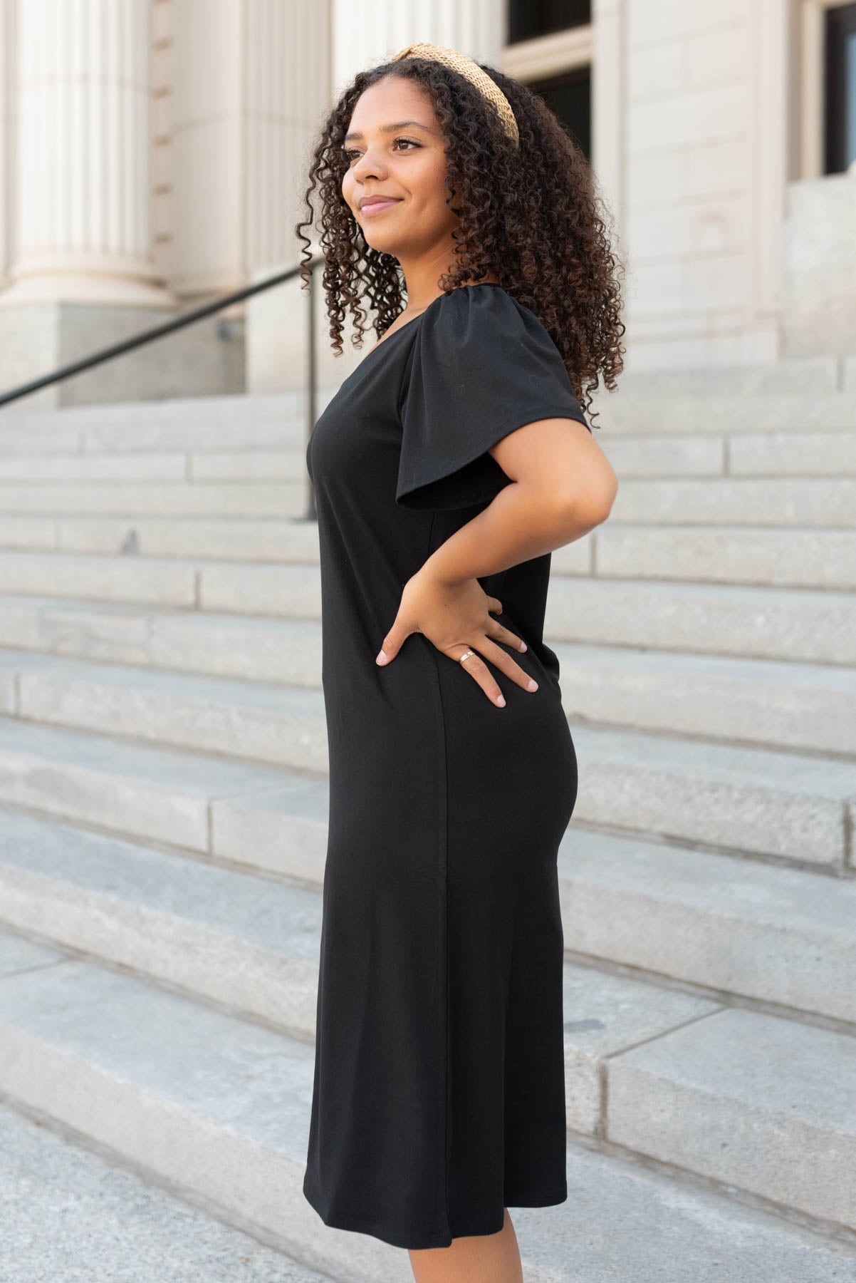 Side view of the black v-neck mini dress