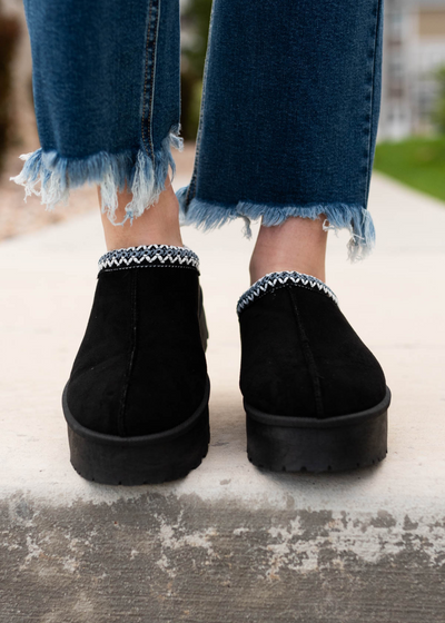 Front view of the black suede clogs