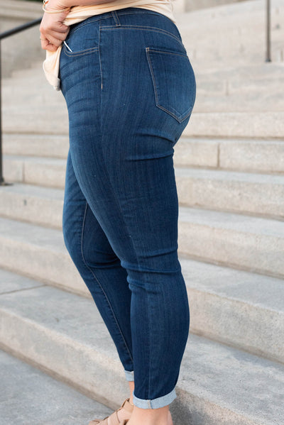 Side view of the plus size dark mid rise jeans