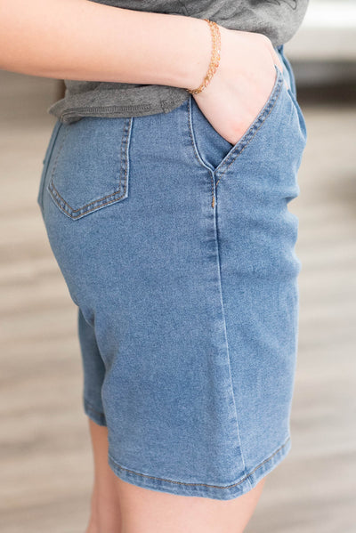 Side view of the denim Bermuda shorts