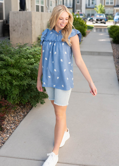 Denim blue floral top with ruffle sleeves