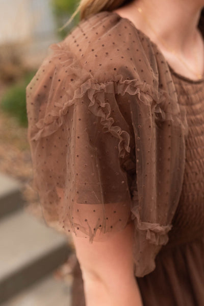 Close up of the sleeve on the brown smocked ruffle dress