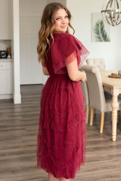 Side view of the burgundy smocked ruffle dress