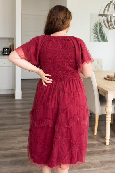 Back view of the plus size burgundy smocked ruffle dress