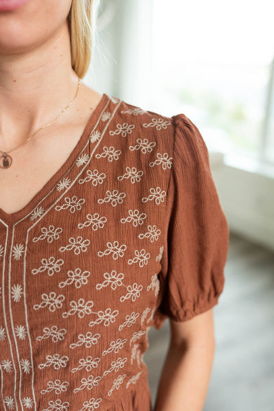 Close up of the bodice and embrodery on the rust embroidered dress