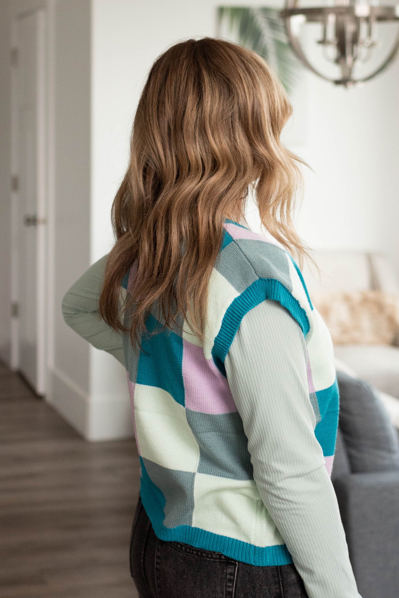 Side view of the teal checkered sweater vest