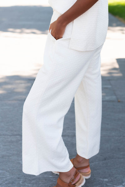 Side view of the ivory knit pattern pants