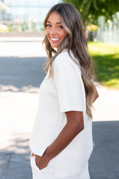 Side view of the ivory knit pattern top