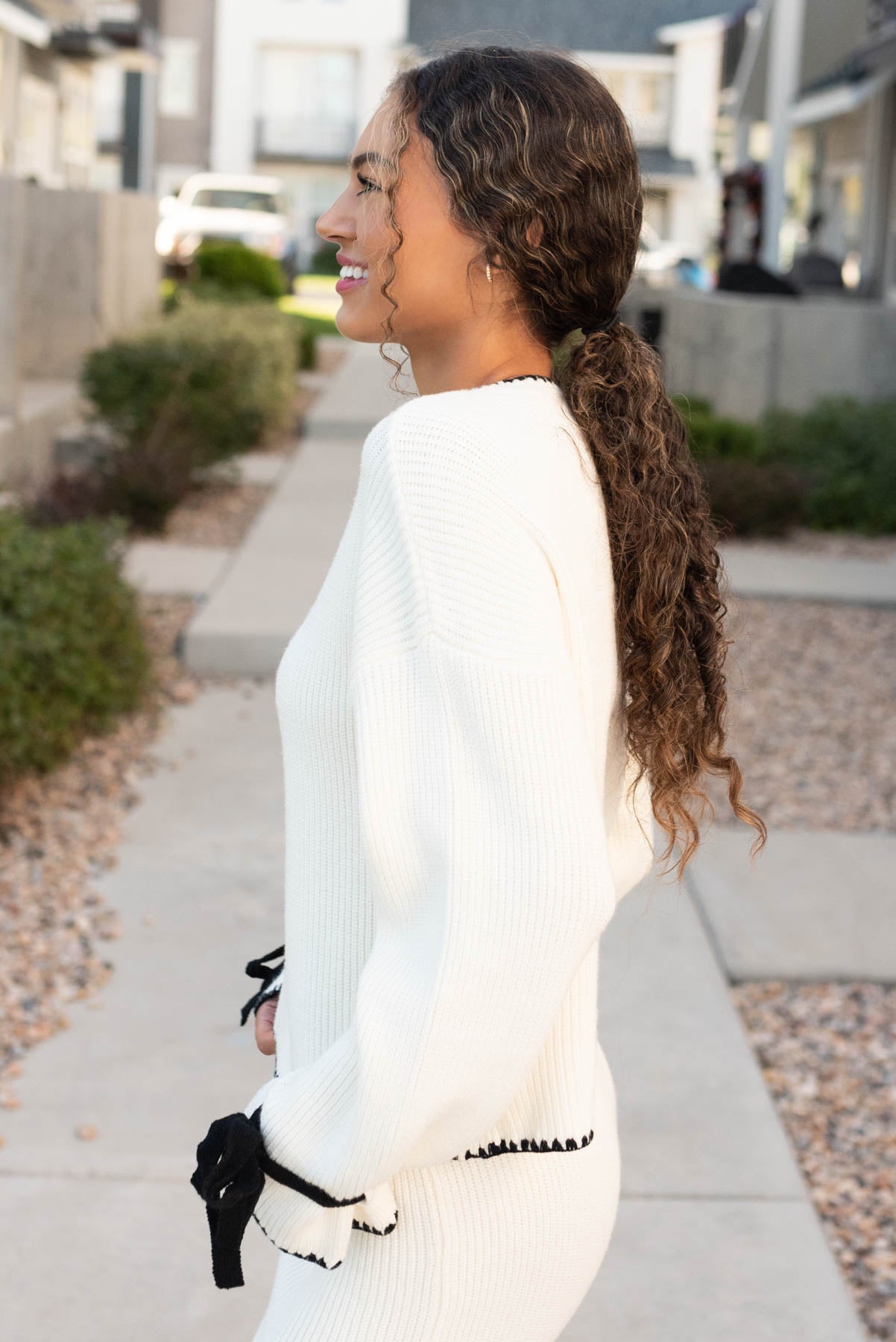 Side view of the cream knit sweater