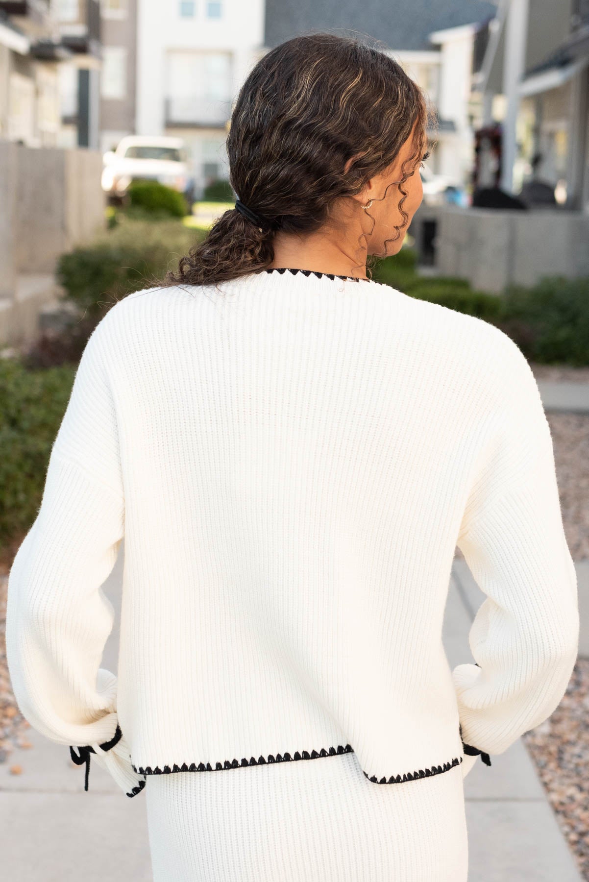 Back view of the cream knit sweater