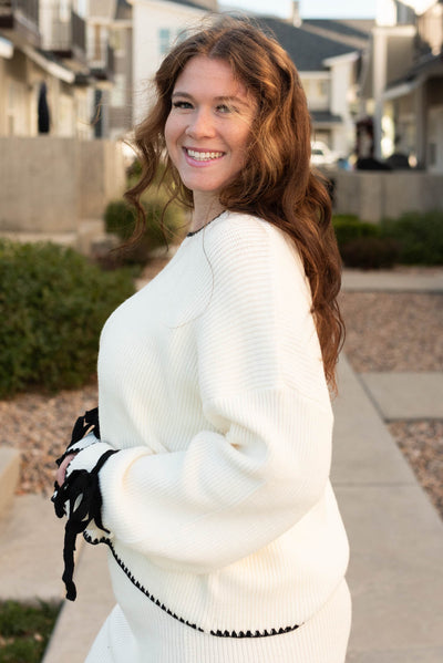 Side view of the cream knit sweater in plus size