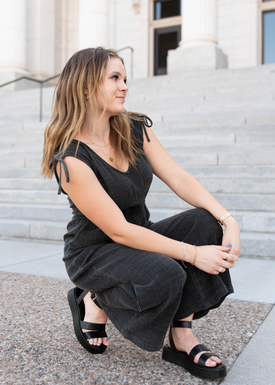 Black mineral wash jumpsuit with ties at the shoulder