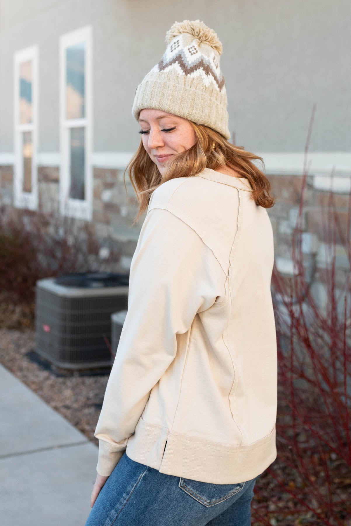 Side view of a taupe sweater