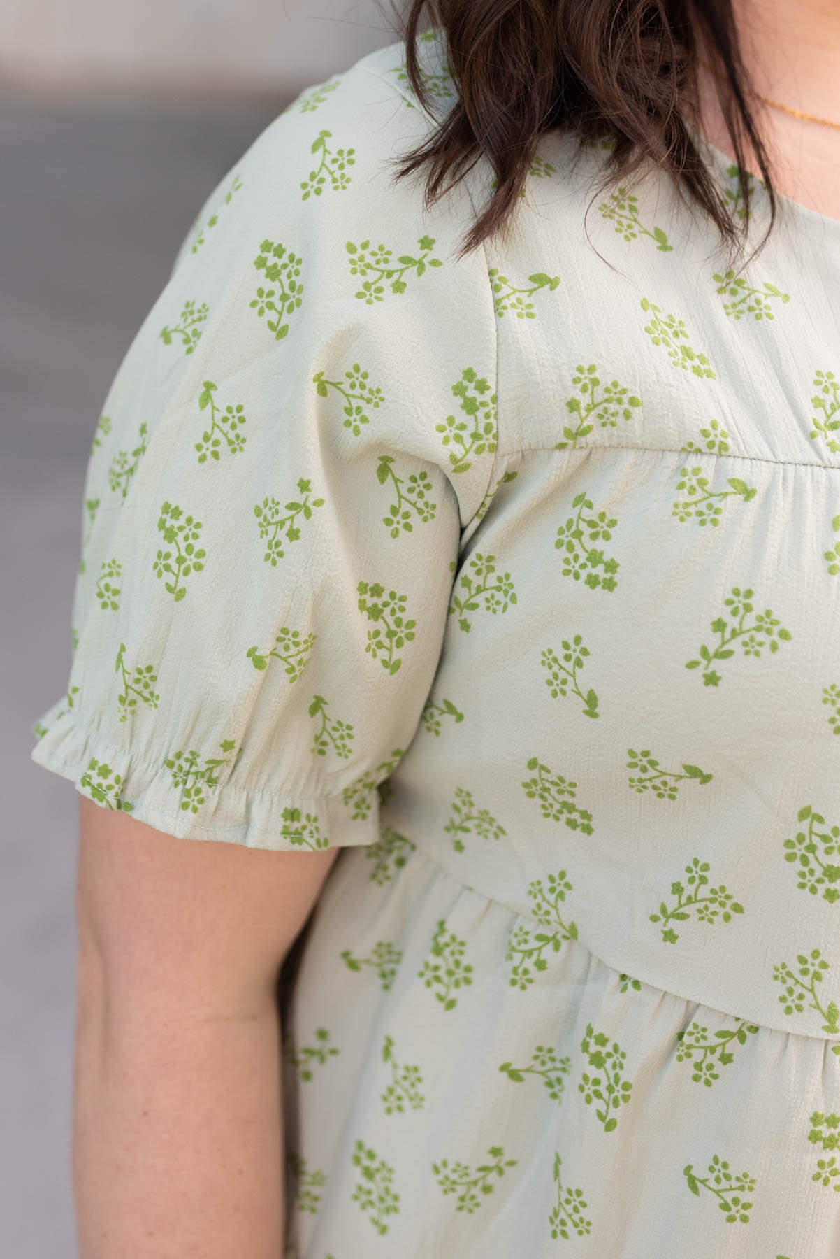 Close up of the sleeve and fabric on the plus size green tiered dress