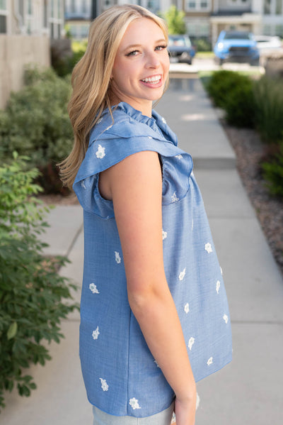 Side view of the denim blue floral top