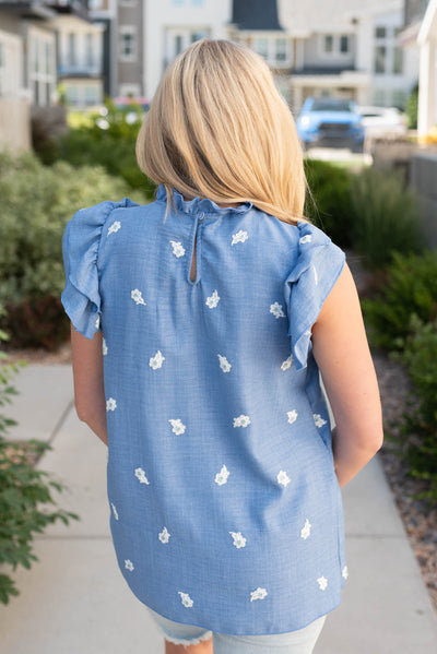 Back view of the denim blue floral top