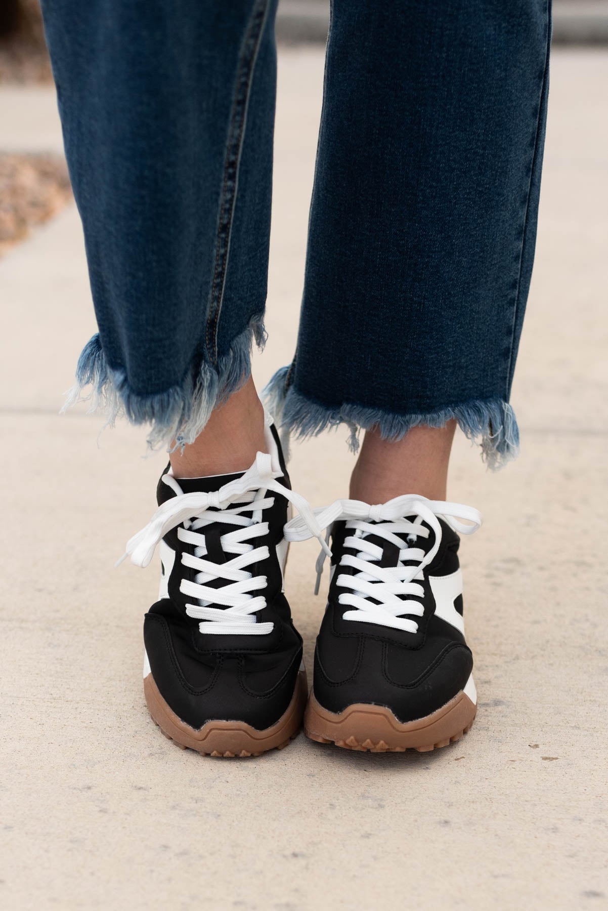 Front view of the blace lace up sneakers