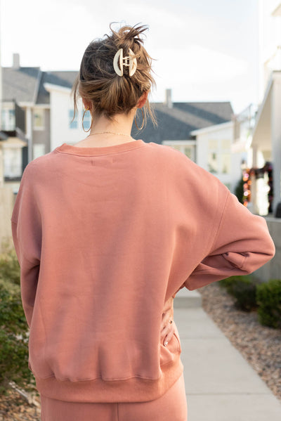 Back view of the dusty rose happy sweater