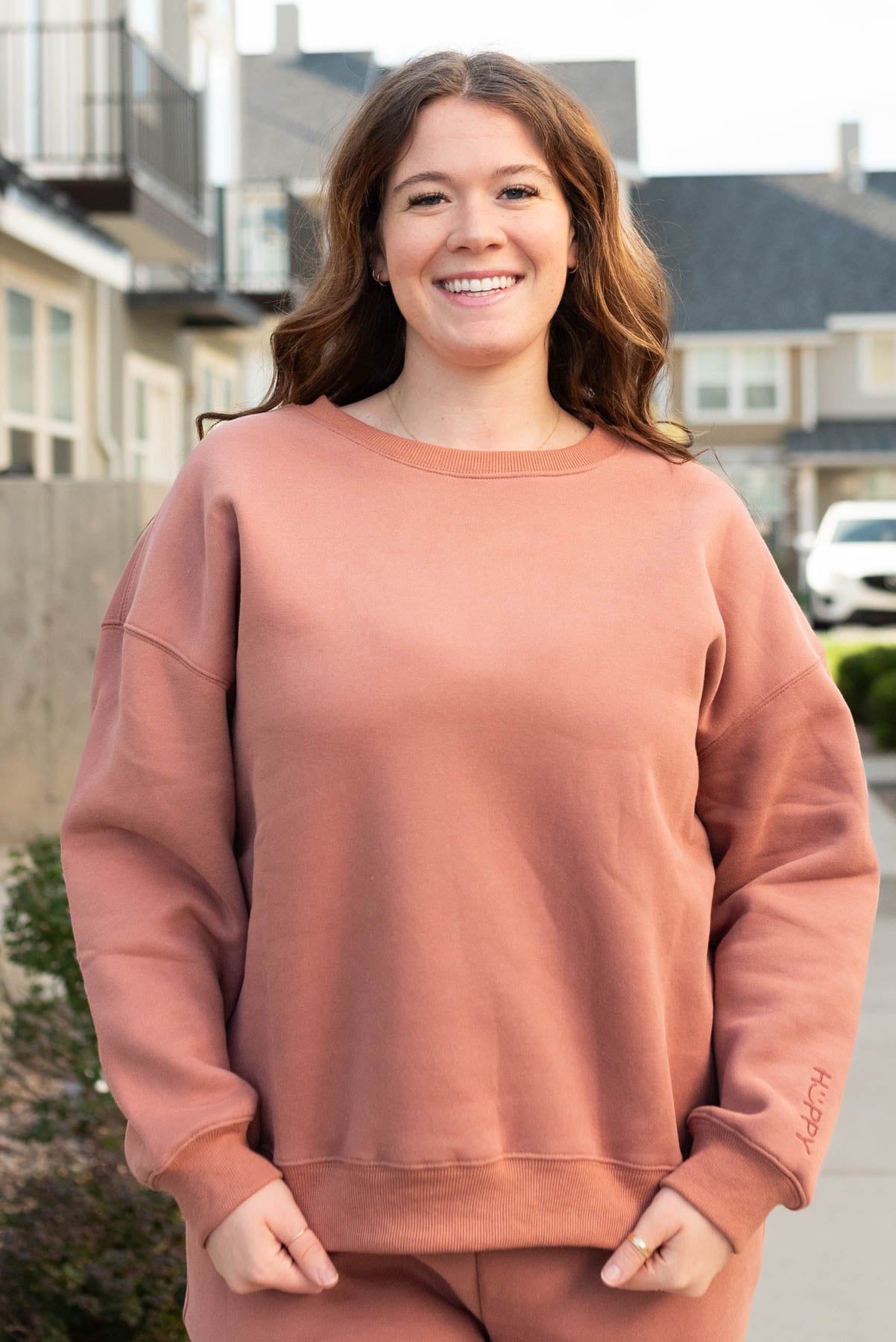 Front view of the plus size dusty rose happy sweater