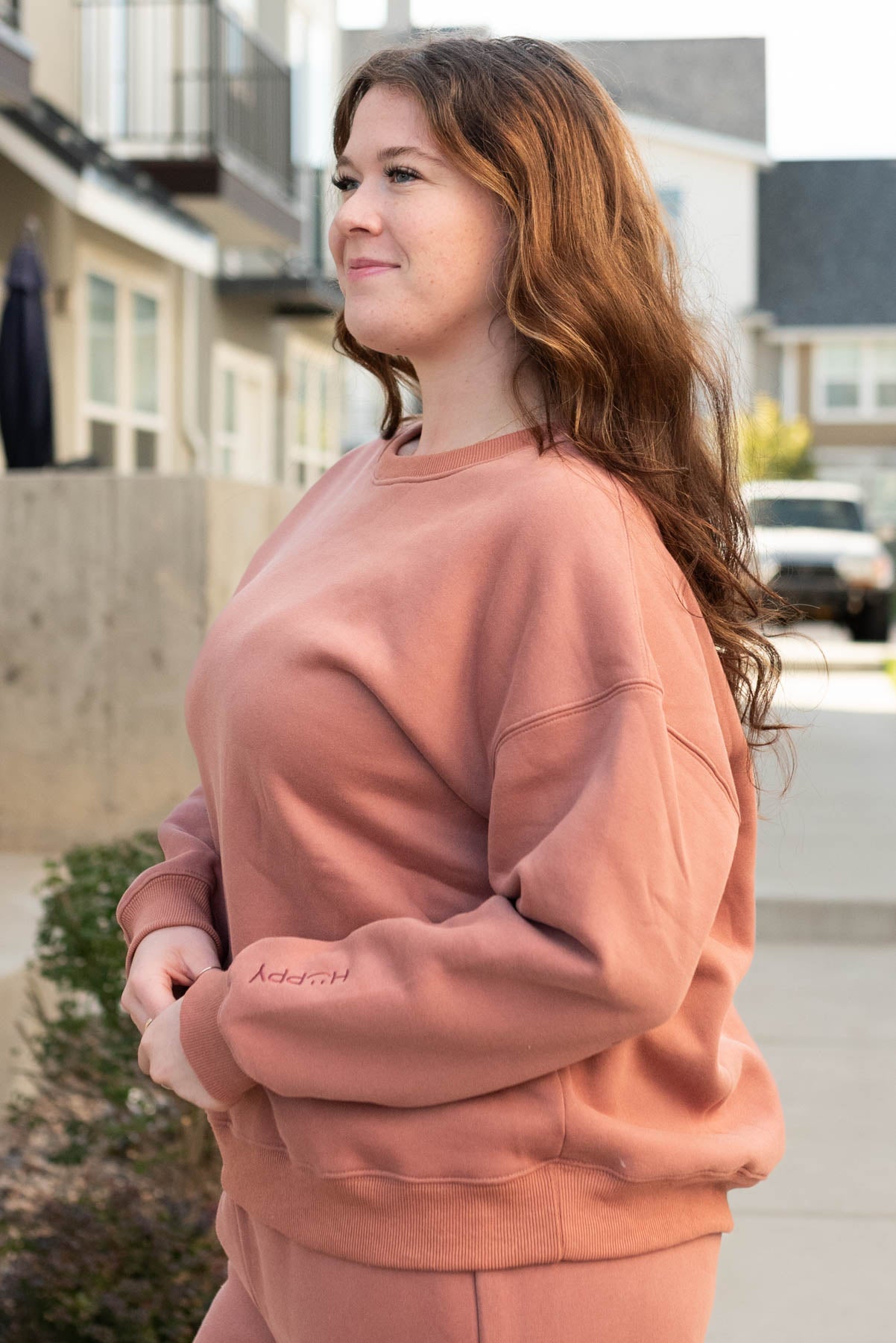 Side view of the plus size dusty rose happy sweater