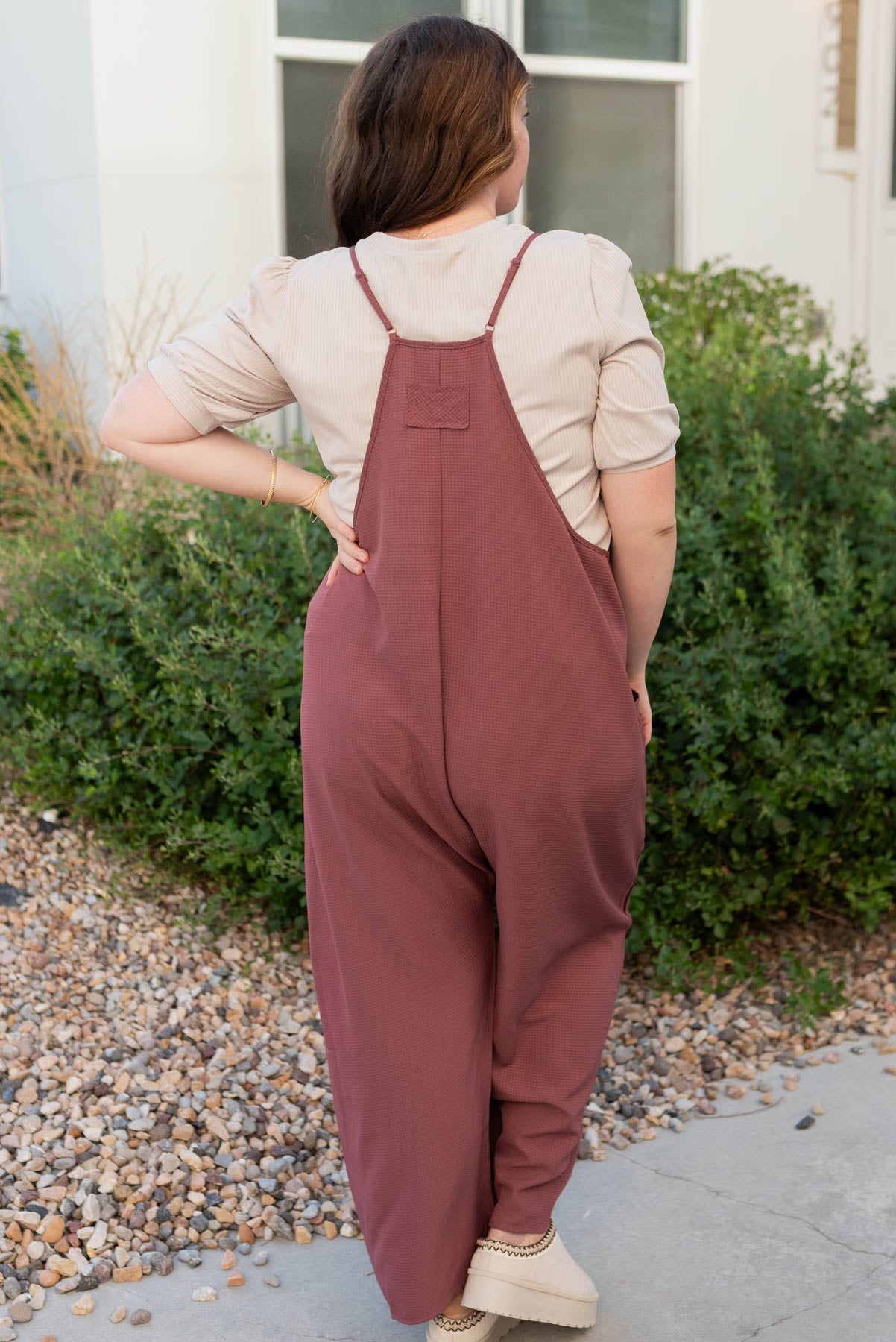 Back view of the plus size mahogany woven overalls