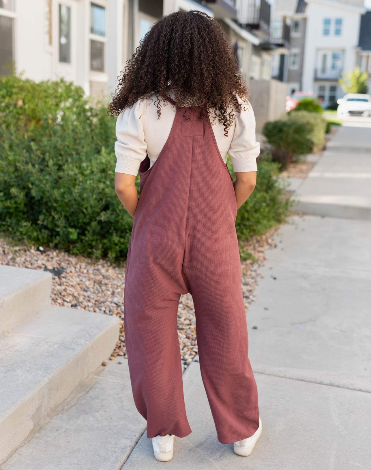 Back view of the mahogany woven overalls