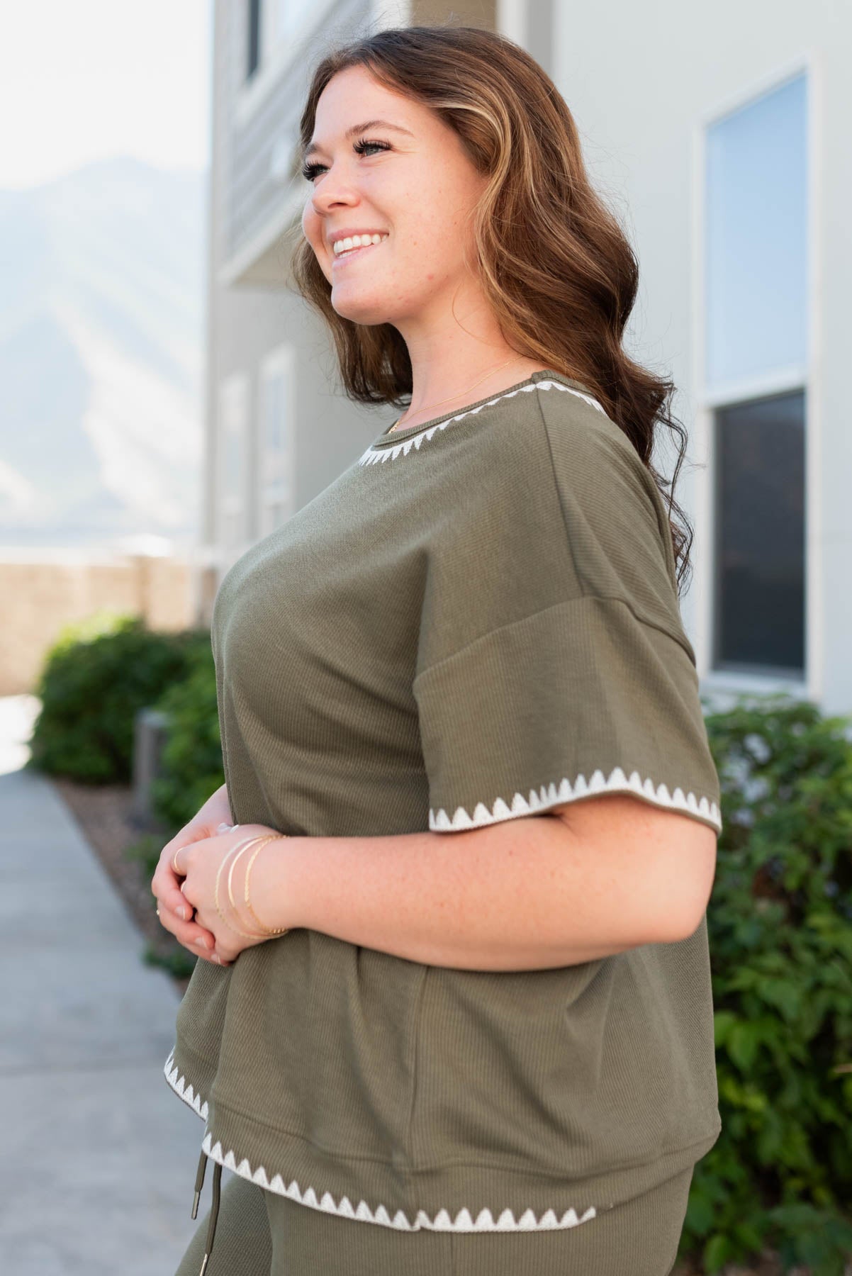 Side view of the olive embroidered top in plus size